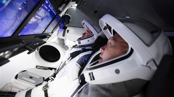 NASA astronauts Bob Behnken, left, and Doug Hurley inside SpaceX's Crew Dragon capsule.