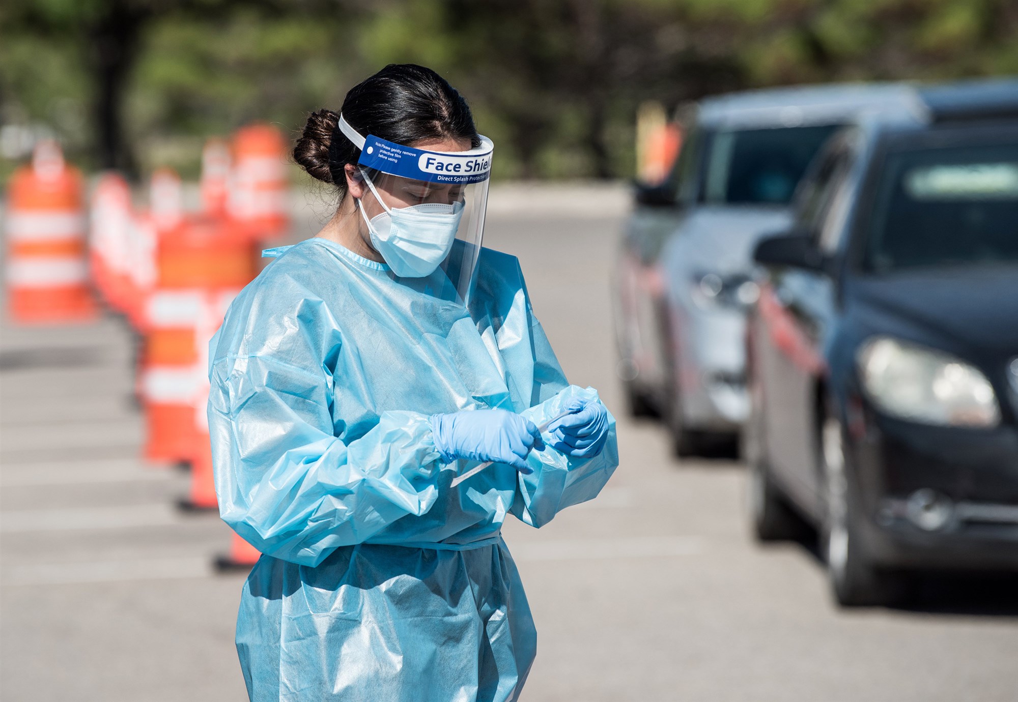 A nurse pulls out a testing swab at a drive-thru site at the El Paso Community College's Valle Verde campus in Texas on July 21, 2020.Cengiz Yar / Getty Images file