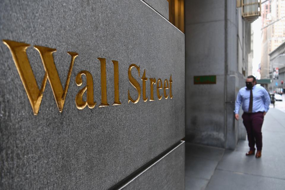 A man walks near the New York Stock Exchange (NYSE) on August 31, 2020 at Wall Street in New York ... [+] AFP VIA GETTY IMAGES